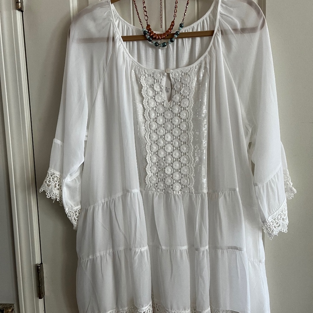 White soft flows top. Will look good with black or bright colored slacks